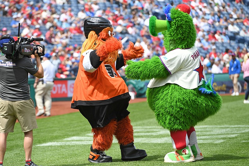 Apr 20, 2025; Philadelphia, Pennsylvania, USA; The Phillie Phantic and Philadelphia Flyers mascot Gritty greet each other during the Phanatic's birthday party before game between Philadelphia Phillies and Miami Marlins at Citizens Bank Park. Mandatory Credit: Eric Hartline-Imagn Images