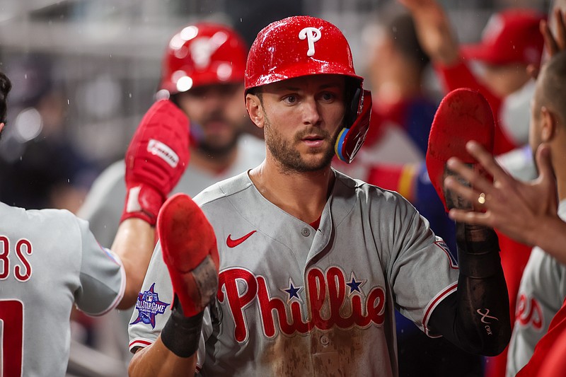 Apr 25, 2026; Atlanta, Georgia, USA; Philadelphia Phillies shortstop Trea Turner (7) celebrates with teammates after scoring a run against the Atlanta Braves in the tenth inning at Truist Park. Mandatory Credit: Brett Davis-Imagn Images