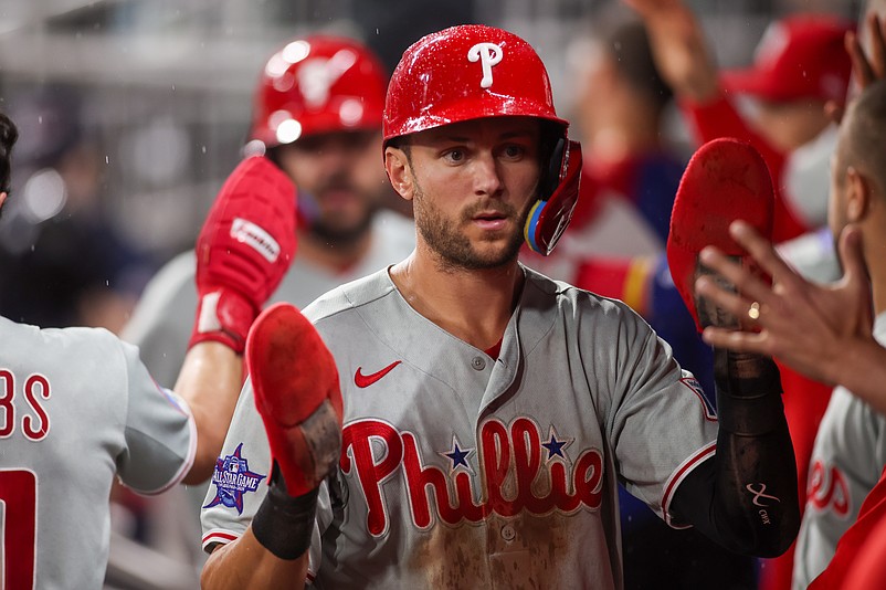 Apr 25, 2026; Atlanta, Georgia, USA; Philadelphia Phillies shortstop Trea Turner (7) celebrates with teammates after scoring a run against the Atlanta Braves in the tenth inning at Truist Park. Mandatory Credit: Brett Davis-Imagn Images