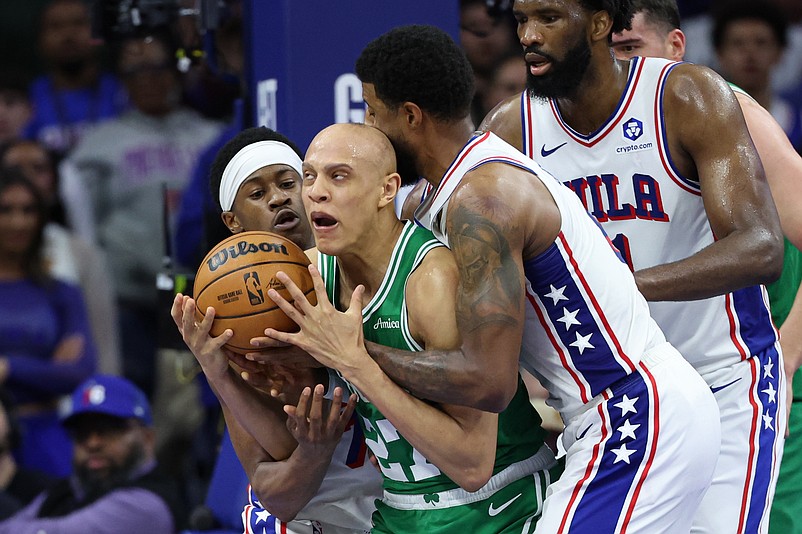 Apr 30, 2026; Philadelphia, Pennsylvania, USA; Boston Celtics guard Jordan Walsh (27) and Philadelphia 76ers guard Vj Edgecombe (77) and forward Paul George (8) wrestle for the ball during the fourth quarter at Xfinity Mobile Arena. Mandatory Credit: Bill Streicher-Imagn Images