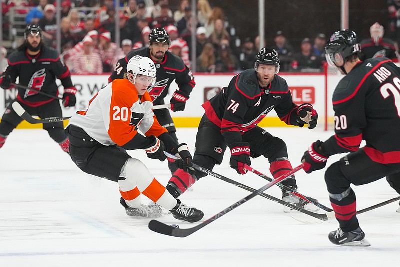 May 2, 2026; Raleigh, North Carolina, USA;  Philadelphia Flyers left wing Alex Bump (20) and Carolina Hurricanes defenseman Jaccob Slavin (74) watch the play during the first period at Lenovo Center. Mandatory Credit: James Guillory-Imagn Images