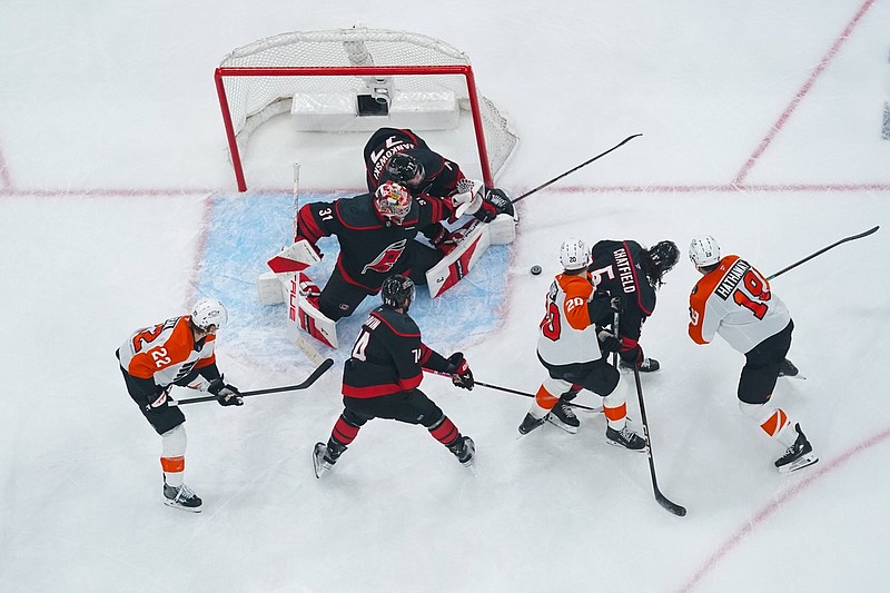 May 2, 2026; Raleigh, North Carolina, USA; Carolina Hurricanes goaltender Frederik Andersen (31) defenseman Jaccob Slavin (74) defenseman Jalen Chatfield (5) and left wing Mark Jankowski (77) stops the shot by Philadelphia Flyers left wing Alex Bump (20) during the third period at Lenovo Center. Mandatory Credit: James Guillory-Imagn Images