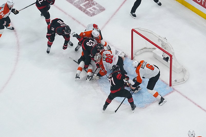 May 4, 2026; Raleigh, North Carolina, USA; Carolina Hurricanes left wing Taylor Hall (71) scores the game winning goal past Philadelphia Flyers goaltender Dan Vladar (80) and defenseman Travis Sanheim (6) during the first overtime in game two of the second round of the 2026 Stanley Cup Playoffs at Lenovo Center. Mandatory Credit: James Guillory-Imagn Images