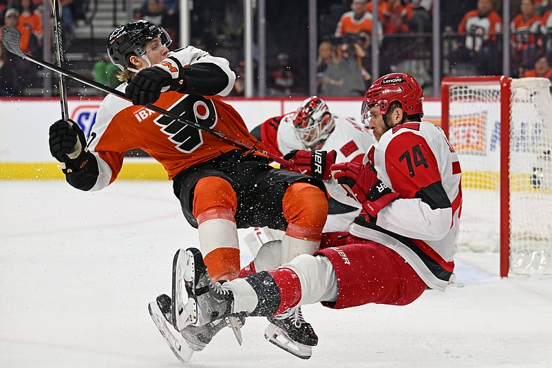 May 7, 2026; Philadelphia, Pennsylvania, USA; Philadelphia Flyers left wing Alex Bump (20) and Carolina Hurricanes defenseman Jaccob Slavin (74) battle during the first period in game three of the second round of the 2026 Stanley Cup Playoffs at Xfinity Mobile Arena. Mandatory Credit: Eric Hartline-Imagn Images