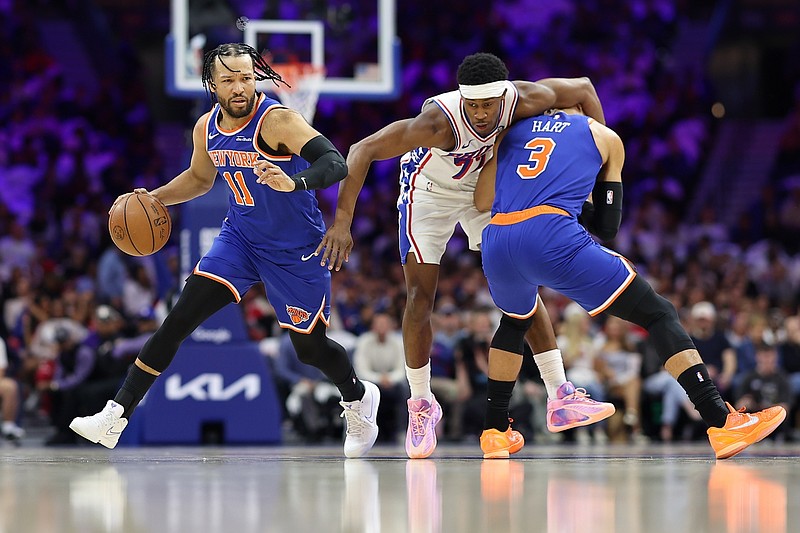 May 8, 2026; Philadelphia, Pennsylvania, USA; Philadelphia 76ers guard Vj Edgecombe (77) is fouled by New York Knicks guard Josh Hart (3) alongside guard Jalen Brunson (11) during the first quarter of game three of the second round of the 2026 NBA Playoffs at Xfinity Mobile Arena. Mandatory Credit: Bill Streicher-Imagn Images