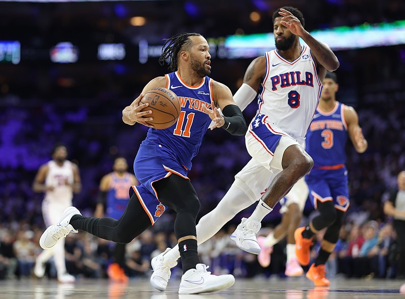 May 8, 2026; Philadelphia, Pennsylvania, USA; New York Knicks guard Jalen Brunson (11) drives against Philadelphia 76ers forward Paul George (8) during the first quarter of game three of the second round of the 2026 NBA Playoffs at Xfinity Mobile Arena. Mandatory Credit: Bill Streicher-Imagn Images