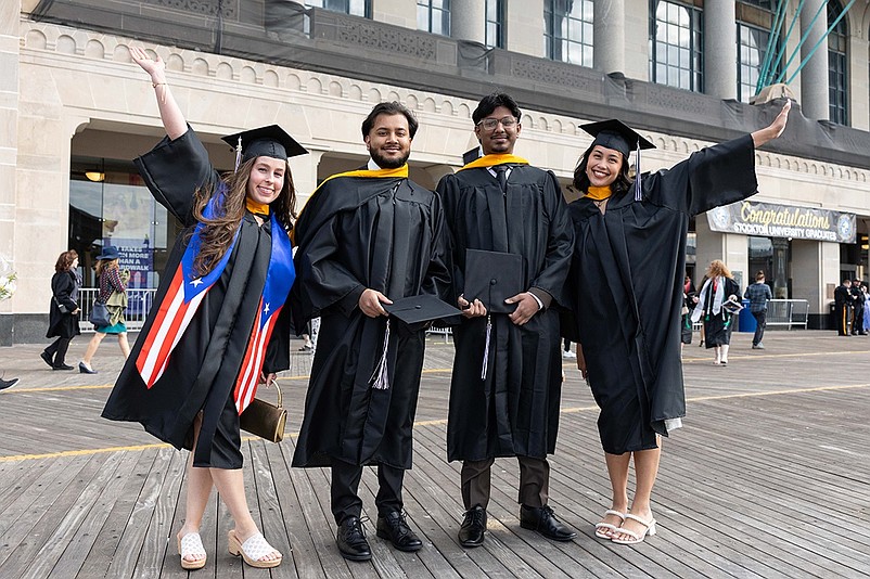 Four of the more than 2,300 Stockton University graduates celebrate outside Jim Whelan Boardwalk Hall in Atlantic City. (Photos courtesy of Susan Allen/Stockton University)