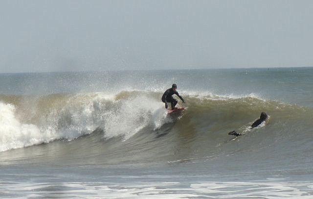 Surfers take advantage of the early-spring swell in Ocean City.