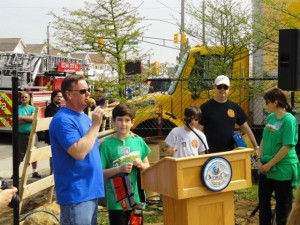 Bill Lavin, founder of the Sandy Ground Project gives his foreman, Nate Wheeler, a work belt.