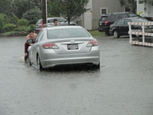 Merion Park residents push a disabled vehicle off Westminster Lane In Merion Park.