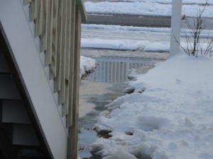 A stream of water flows from burst pipes to the street along the side of Jackie Mittleman's home on 23rd Street.