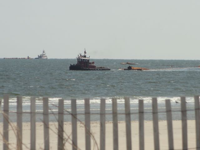 A tug drags sections of pipeline on Monday, March 23, as the Army Corps of Engineers prepares for a project to rebuild eroded beaches at the southern end of Ocean City, NJ.