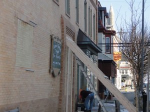 The exterior wall of the brick building appears to be bulging outward between the first and second floors.