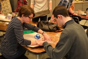 Kira Kelly and Justin Trowbridge make Rice Krispies treats as part of a monthly group gathering of 'Best Buddies' at Ocean City High School on Monday.