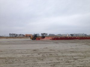 Sections of pipe stacked at 34th Street Beach will be added to a line as a beach replenishment project moves northward from 42nd Street to 36th Street.