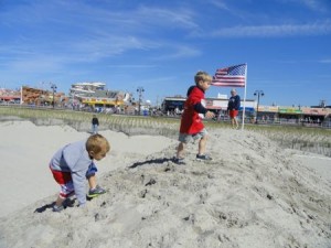 A pair of competitors in the kids' run crest a sand mound on the way to the finish line.