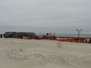 Metal cages used to filter debris from the dredging slurry and some other equipment is on the back of the beach at 55th Street on Friday, June 5.