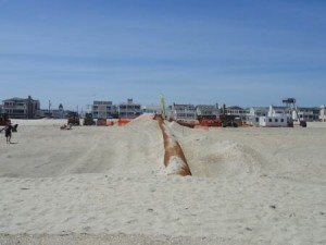 Some heavy equipment is stored at the back of the beach just north of the 55th Street entrance, where  a pipeline from offshore makes landfall.