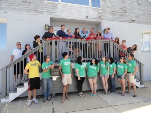 Ocean City Theatre Company Artistic Director Michael Hartman (top center) cuts the ribbon marking the opening of a new home to OCTC in June.