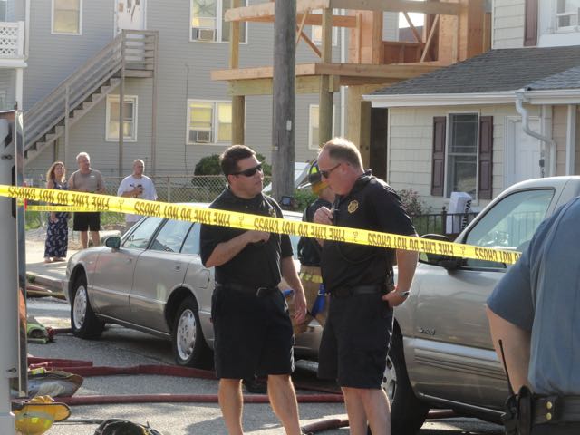 Deputy Fire Chief Jim Smith (left) talks with Fire Chief Chris Breunig at the scene.