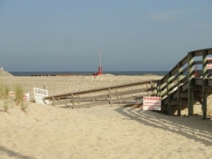 A new line of dunes buries the walkway at 58th Street. Dune crossover work will follow sand-pumping operations.