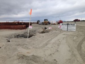 Much of the 59th Street jetty is buried by a new dune line, but a small bit of rocks still poke through the rebuilt beach near the 58th Street lifeguard headquarters.