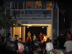 The neighborhood gathers around Steve Sands' ground-level garage to watch Mr. Steve's 1st Street Talent Show.