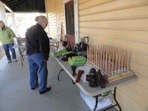 Visitors look at artifacts from U.S. Life Saving Station 30, including a flaking box, decoys, lanterns and torches.