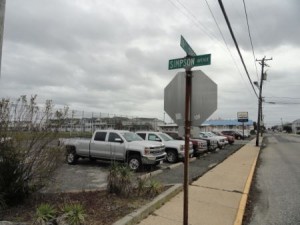 The lot is currently paved and leased by the Perry Egan Chevrolet dealership. It includes a small garage at one end.