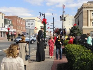 A stiltwalker chats with Earlier Than the Bird shoppers in November in Ocean City.