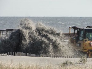 Slurry flies from a pipeline and onto the beach at St. Charles Place on Tuesday, Nov. 24.