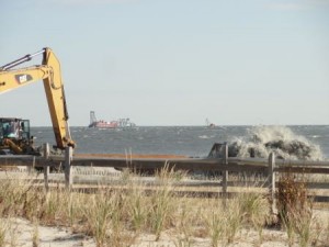 The dredge Illinois (background) is vacuuming sand from a borrow area off Surf Road and pumping it through an underwater pipeline to the beach in Ocean City, NJ.