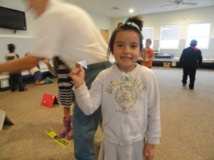 Lily Floras, 6, shows off her paper aircraft.