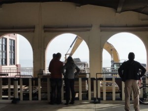 Equipment and sand-pumping operations surrounded the Music Pier on Sunday.