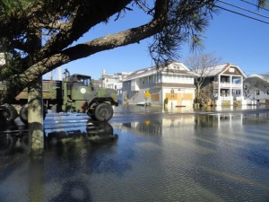 One of the city's military surplus vehicles capable of driving through flood waters drives past the flooded intersection of 11th Street and Bay Avenue on Sunday morning.