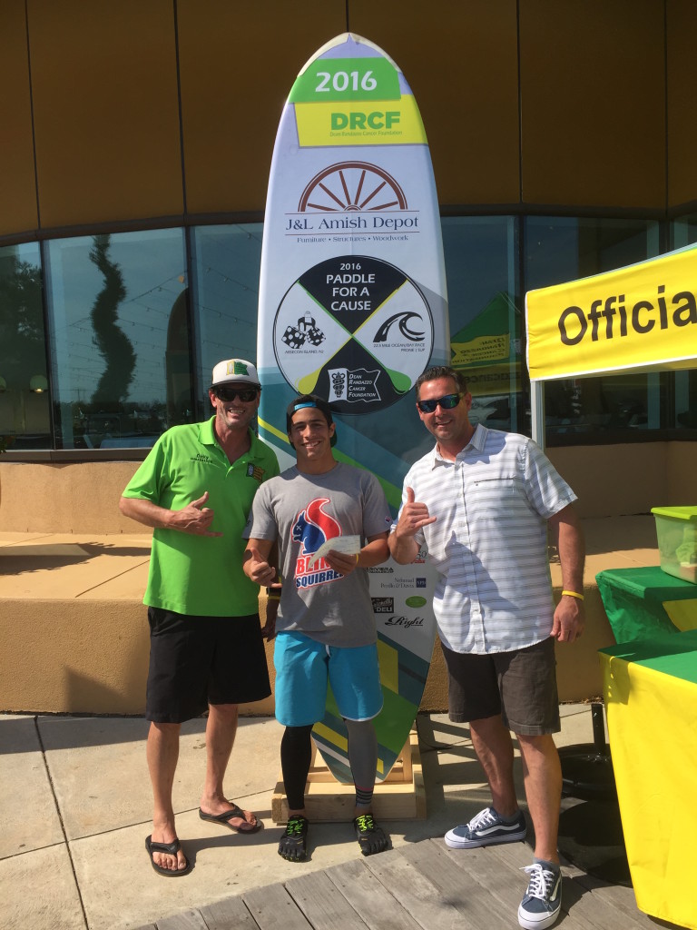 Dean Randazzo Cancer Foundation Ambassador Richard Nugent of Margate and Past President and Race Director Paul Giunta of Somers Point award Quintin Chiapperino, 19, of Saint Croix, U.S. Virgin Islands with a $1,000 check for his win in the 22.5-mile Paddle For A Cause presented by J&L Amish Depot.