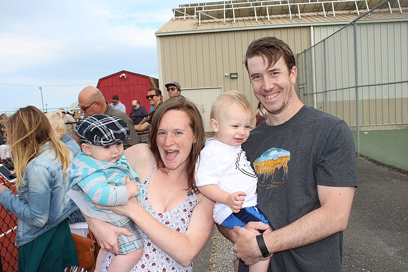 Megan Scherer holds Levon Bruce and John Steindel holds son Dylan.  They were at Carey Stadium to celebrate the graduation of Ethan Douris.