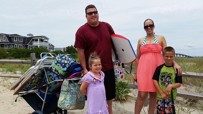 Rob and Charis Cain, of Buena Vista Township, N.J., joined by children Gabriella and Robby, head out to the beach.