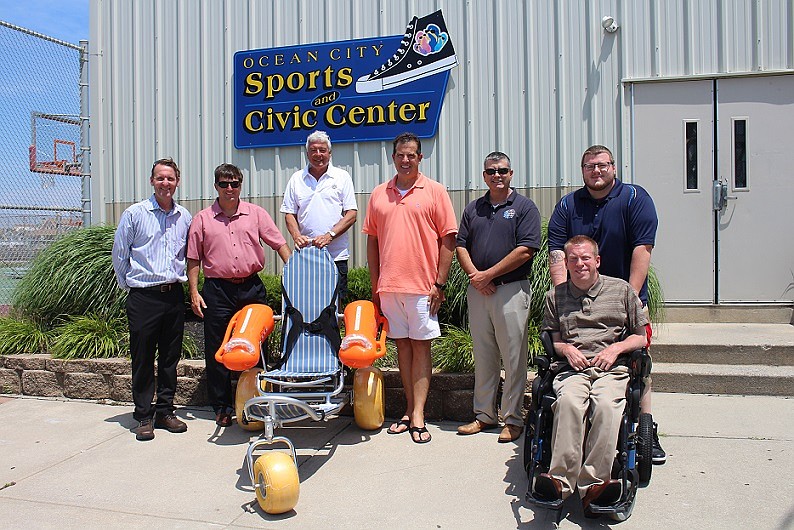 The Exchange Club of Ocean City donated five Mobi Chair beach access wheelchairs enabling people with physical challenges to easily access the beach and ocean.  From left are Mayor Jay Gillian, Exchange Club President Frank Faverzani, John Lugo and Mark Kampf, both of the Exchange Club, City Administrator Jim Mallon, Scott Denney, Executive Assistant to Bob Barr, and Bob Barr (front). 