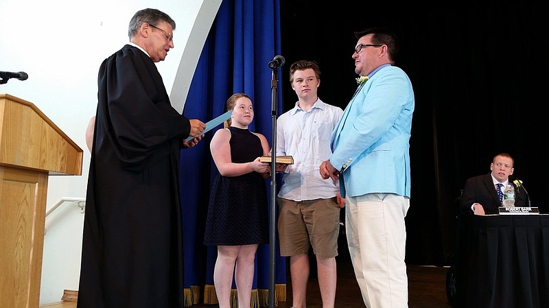 Third Ward Councilman Tony Wilson is accompanied by his children, Anthony and Julia Marie, during his swearing in by Municipal Court Judge Richard Russell after the 2016 election.