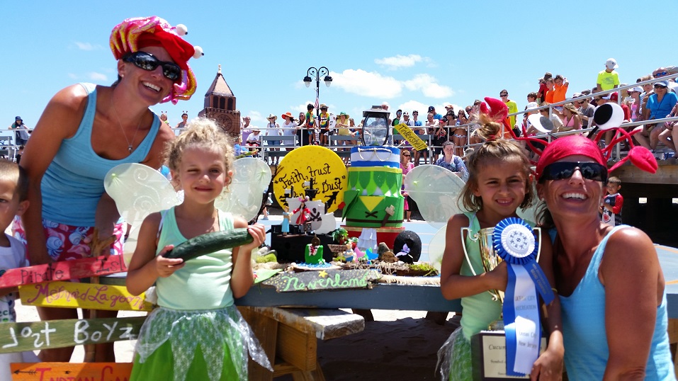 Twin sisters Emily McCarthy and Julie Marzano, of Springfield, Pa., are joined by their daughters Maura and Nadia in front of their winning crab Tinker Shell at the Miss Crustacean beauty pageant.