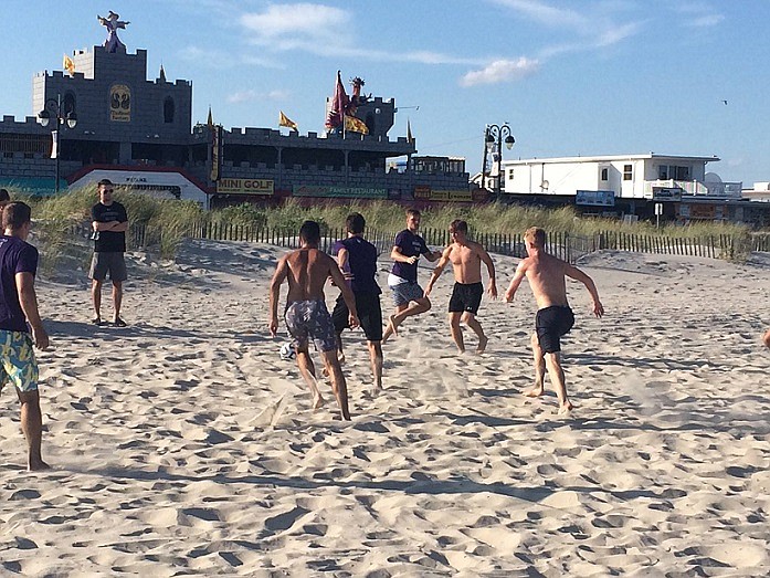 Northwestern's men's soccer team scrimmaging on the OC beach during their recent camp here.