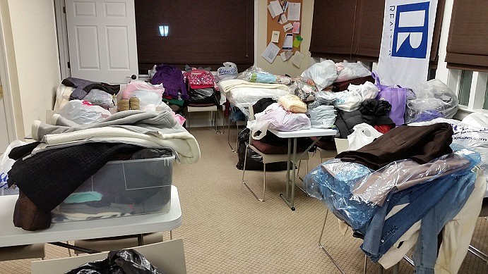 Virtually an entire room at the Board of Realtors office on 22nd Street is stocked with donated clothes and bedding.