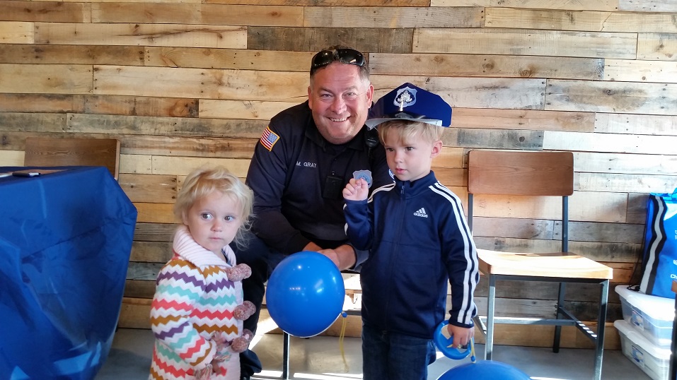 Officer Mike Gray of the Ocean City Community Policing Unit, shares a light moment with Luci and Ben Dougherty.