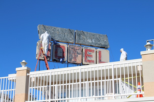 Workers sandblast the iconic neon sign of the Sifting Sands Motel on 9th St. 