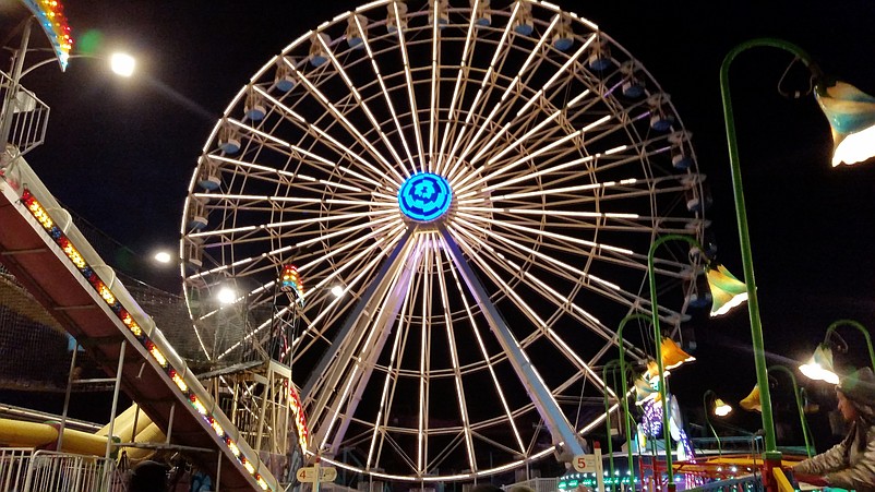 The towering Ferris wheel was lit up at night during its heyday at Wonderland Pier, but now it is dark and idle.