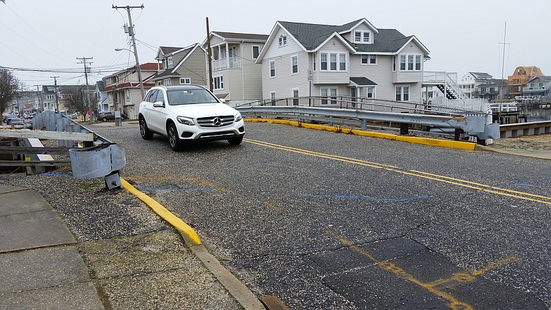 An SUV crosses over the tiny 17th Street Bridge, which is being replaced with a new span.