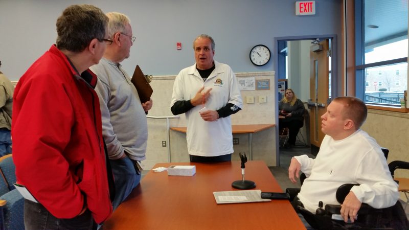 Councilmen Keith Hartzell and Bob Barr, both in white shirts, talk to residents after the meeting.