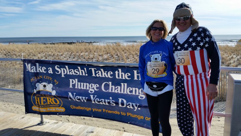 Denise and Jim Berghaier, who have a summer home in Ocean City, pose in front of a Boardwalk banner promoting the HERO Campaign plunge. Jim wore a colorful costume for his first ever plunge.