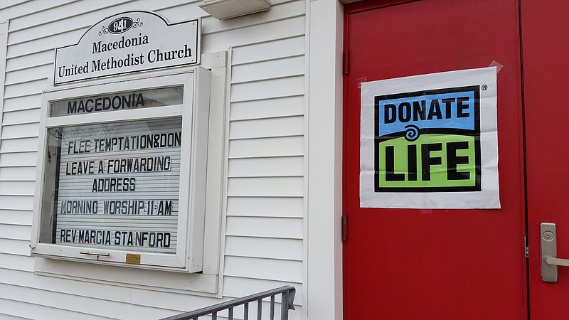 A sign on the door of the Macedonia United Methodist Church urges people to become organ donors.